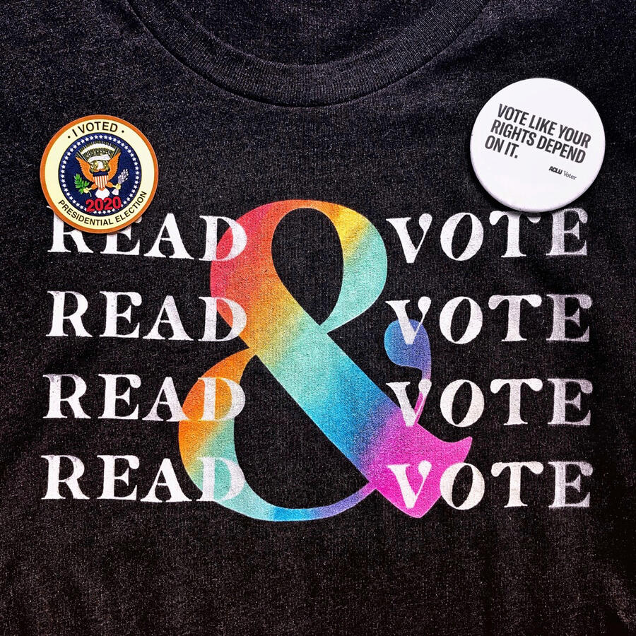 My favorite dark-grey t-shirt says “Read & Vote” repeated four times with white and rainbow letters. An “I voted” sticker and a button from the ACLU that reads, “Vote Like Your Rights Depend on It.” adorn the shirt.